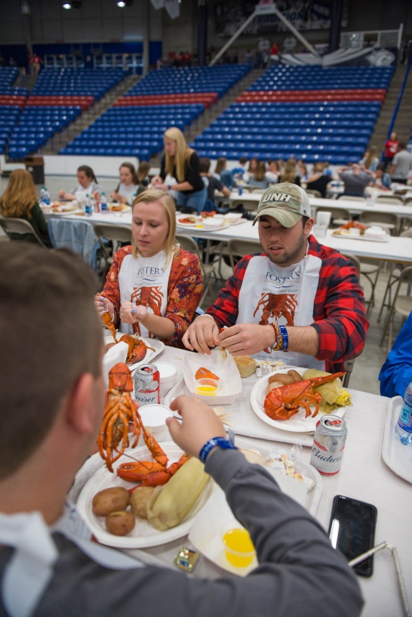 UNH seniors celebrating their impending graduation with classmates over lobster in the rough 