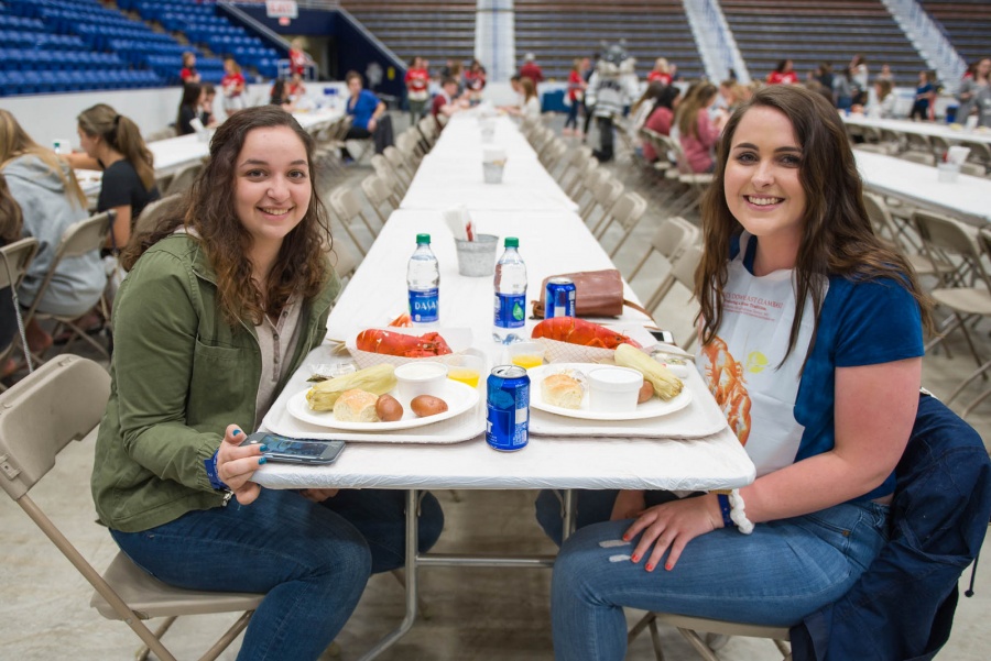 UNH seniors celebrating their impending graduation with classmates over lobster in the rough 