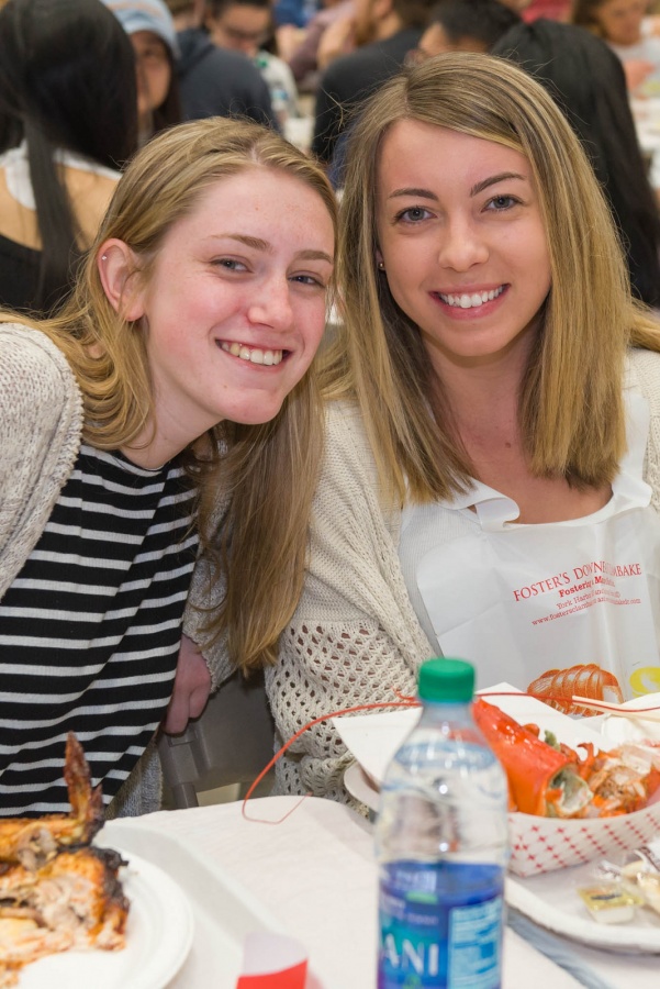 UNH seniors celebrating their impending graduation with classmates over lobster in the rough 