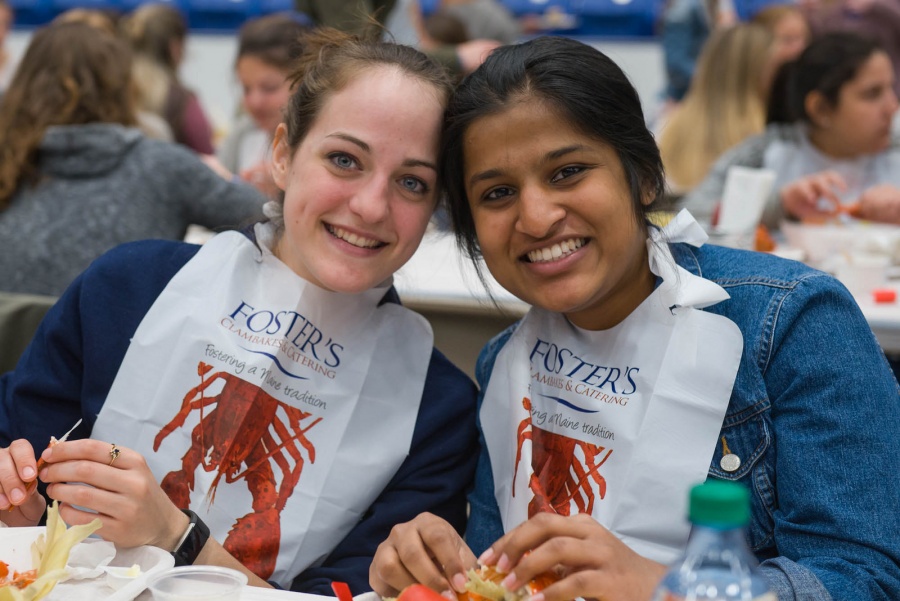 UNH seniors celebrating their impending graduation with classmates over lobster in the rough 