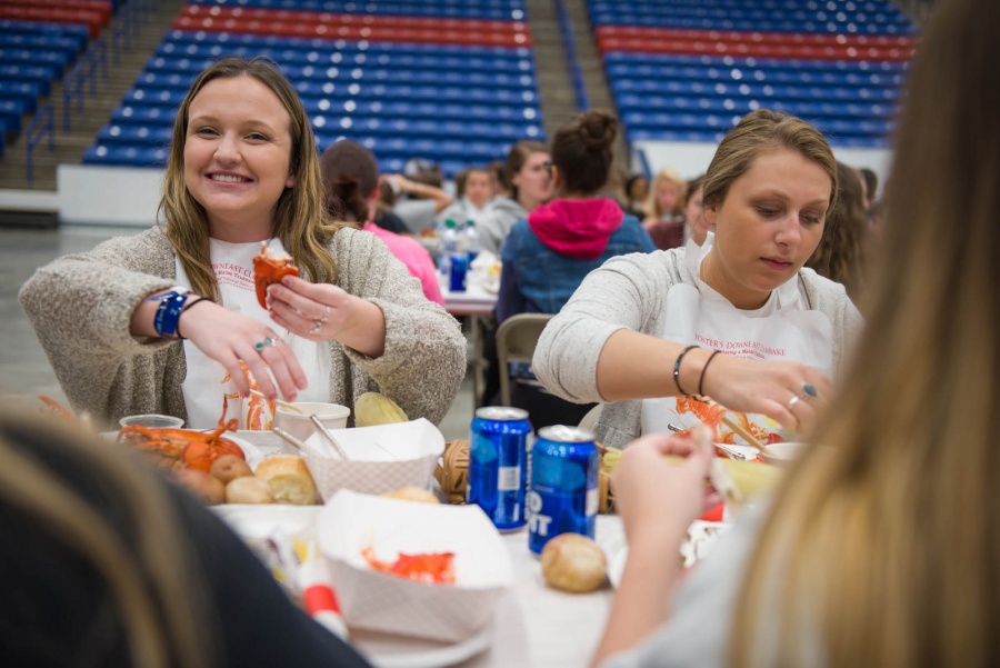 UNH seniors celebrating their impending graduation with classmates over lobster in the rough 