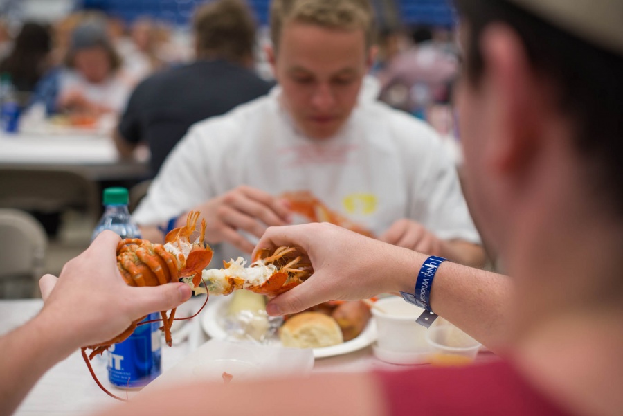 UNH seniors celebrating their impending graduation with classmates over lobster in the rough 