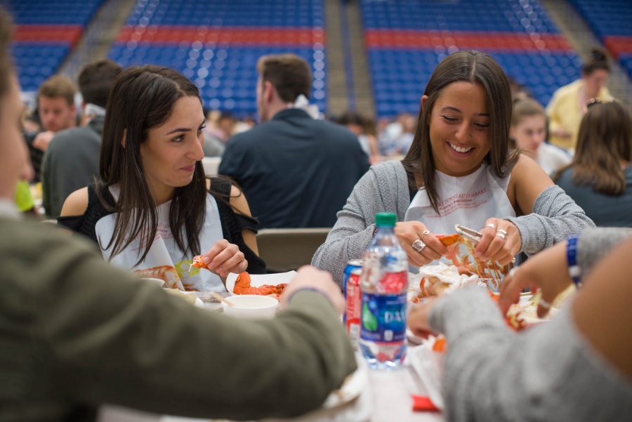 UNH seniors celebrating their impending graduation with classmates over lobster in the rough 