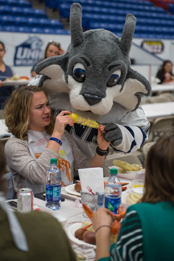 UNH seniors celebrating their impending graduation with classmates over lobster in the rough 