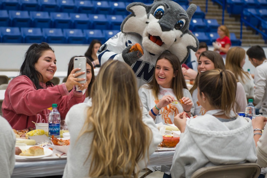 UNH seniors celebrating their impending graduation with classmates over lobster in the rough 