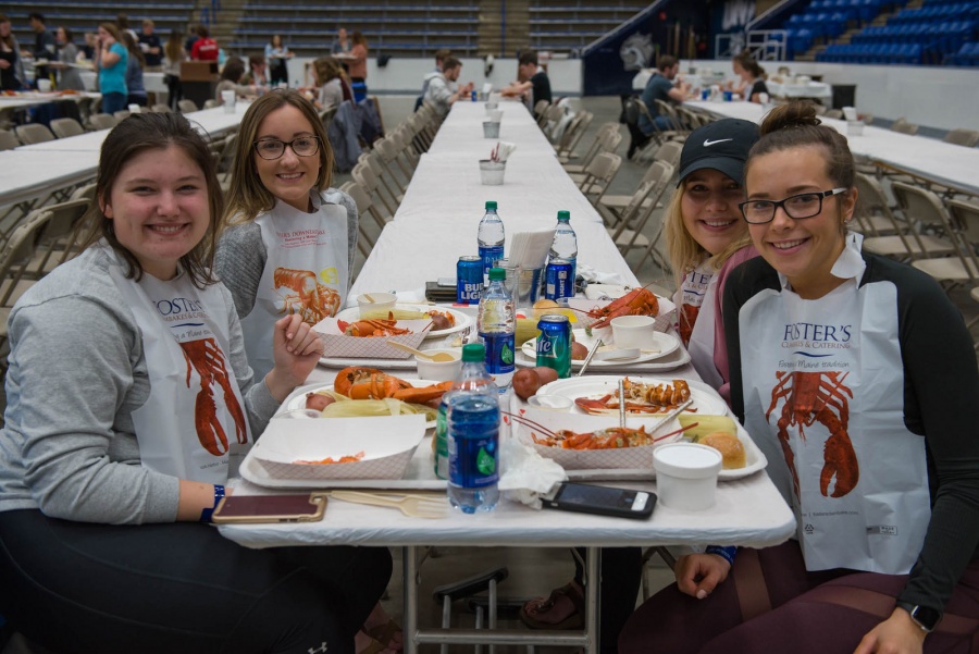 UNH seniors celebrating their impending graduation with classmates over lobster in the rough 
