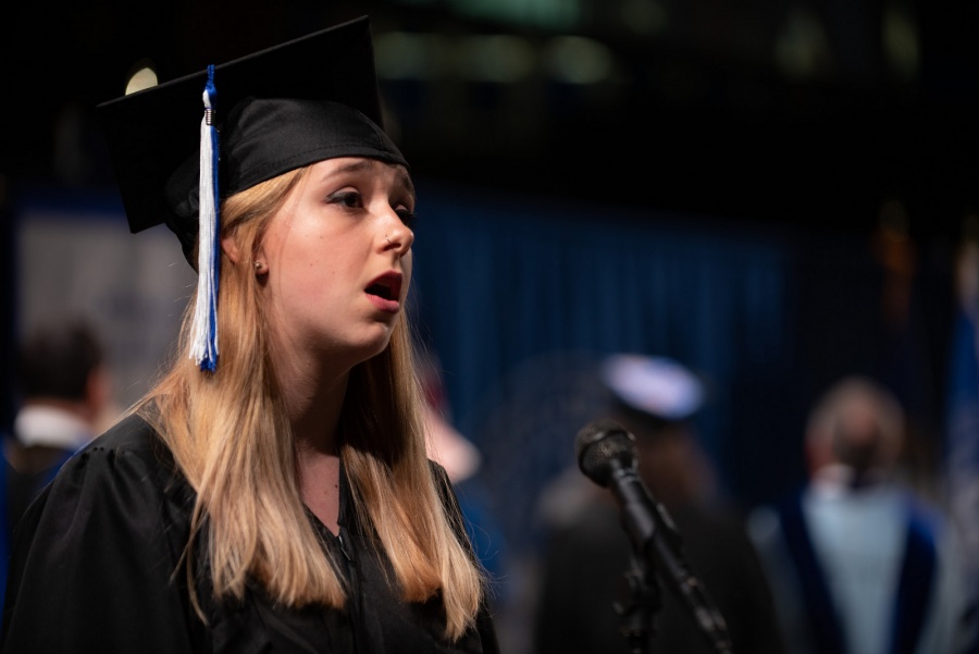 A UNH student receives their cord