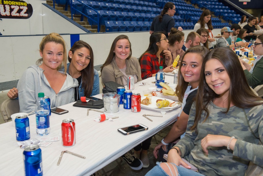 UNH seniors celebrating their impending graduation with classmates over lobster in the rough 