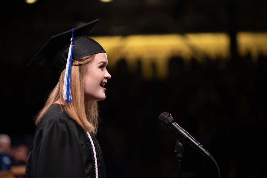 A UNH student receives their cord