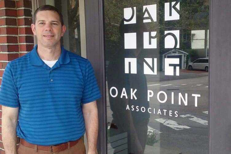 UNH graduate Robert Bender '17 in front of Oak Point Associates