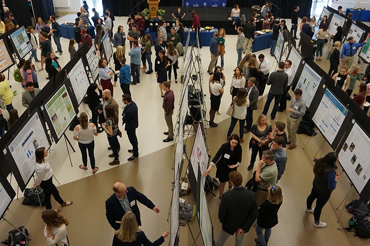Aerial view of presenters at COLSA's URC poster presentation.