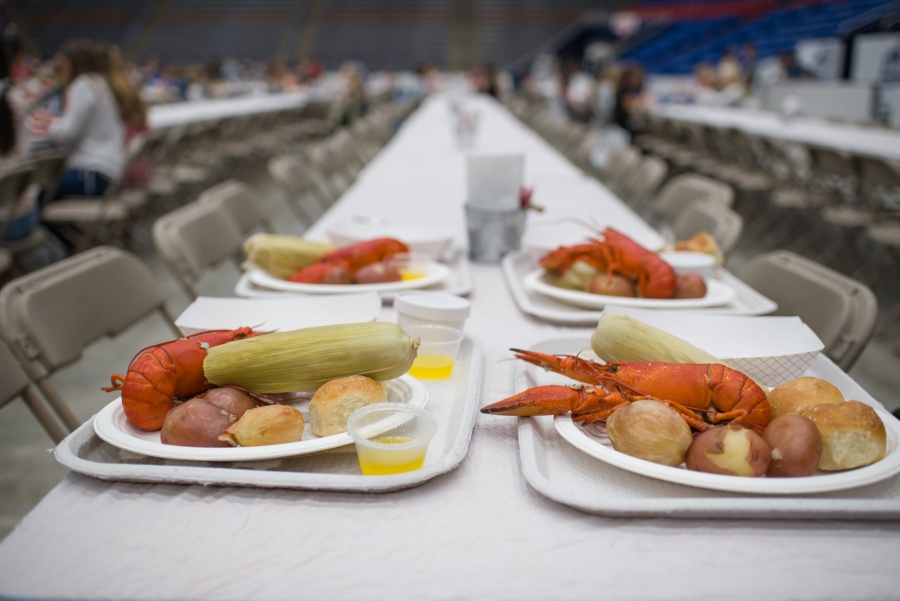 UNH seniors celebrating their impending graduation with classmates over lobster in the rough 