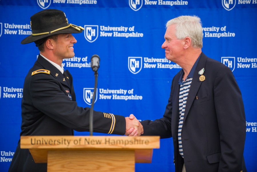 UNH outgoing President Mark Huddleston at lectern