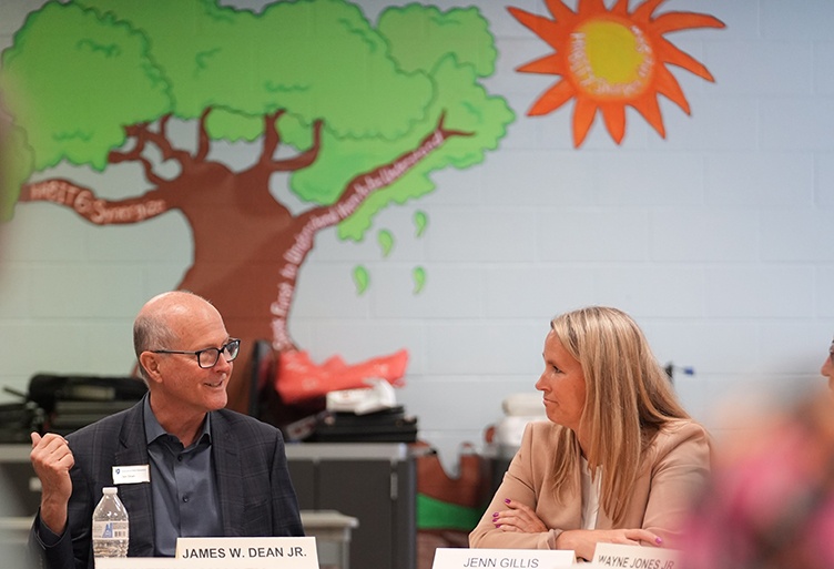 President Dean speaks with the superintendent of Manchester schools