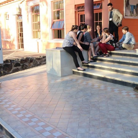 students on steps outside institution