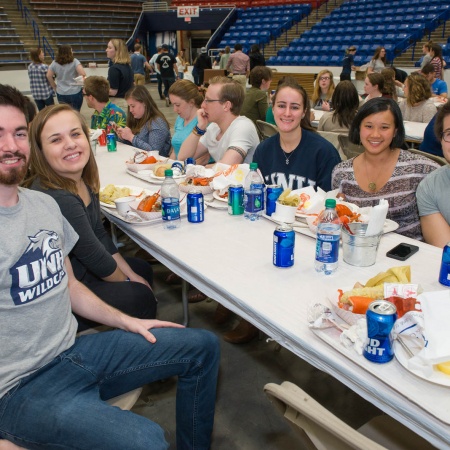 UNH seniors celebrating their impending graduation with classmates over lobster in the rough 