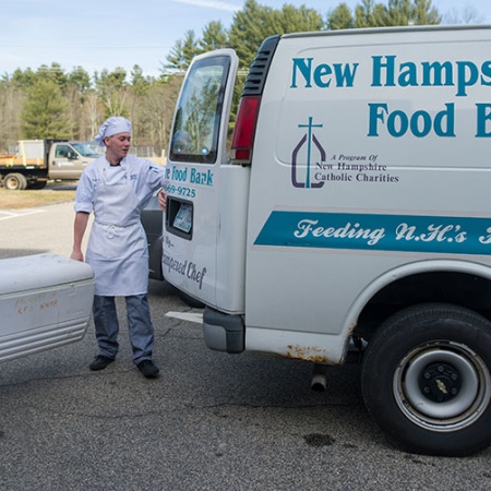 Brad LaMonica and Ciara McCarter from UNH’s Thompson School of Applied Science Culinary Arts & Nutrition program load tilapia onto N.H. Food Bank truck