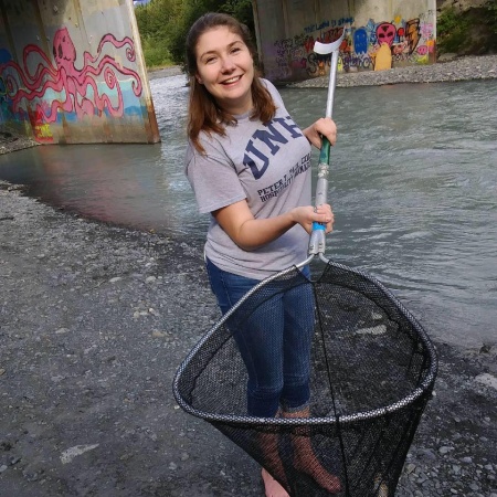 Genevieve Wolfe catching salmon in a net