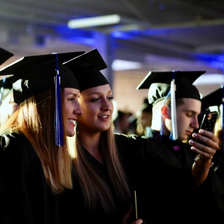 UNH Manchester graduates pose for a selfie during commencement 2018