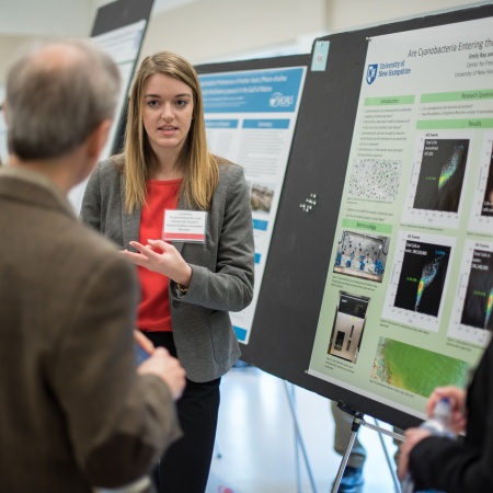 A student from the UNH College of Life Sciences and Agriculture presents her research poster during the 2018 Undergraduate Research Conference
