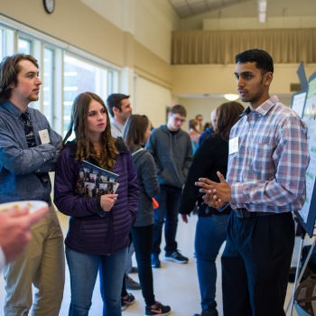 A male UNH student presents his research findings during the 2018 UNH Undergraduate Research Conference