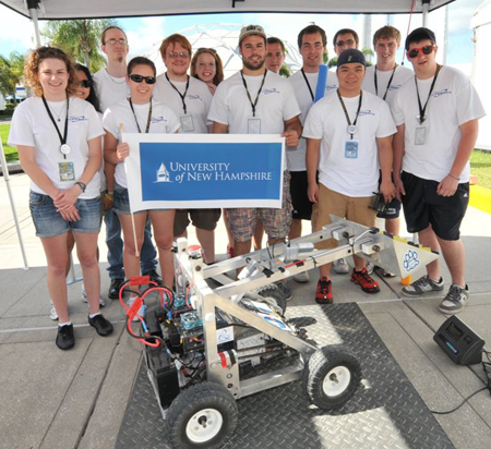 Lunabotics 2012team.jpg: The 2012 UNH LunaCats. L-R: Caleigh MacPherson, advisor May-Win Thein (hidden), Jonathan Wilson, Camille Poulin, Anthony Morin, Elizabeth Campbell, Tadd Smith, Jacob Chamberlin (partially hidden), Andrew Kennedy, Hao Hoang, Patrick Merrill (behind Hao), Eric Beiswenger, Jaron Peters.