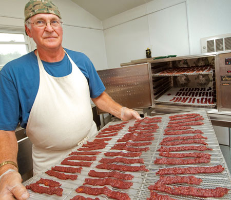 Bert von Dohrmann removes a tray of beef jerky