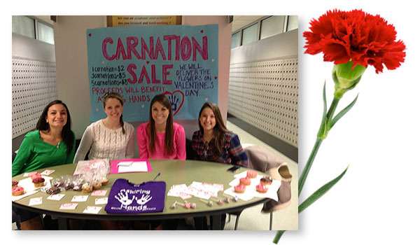 Aspiring Hands selling carnations