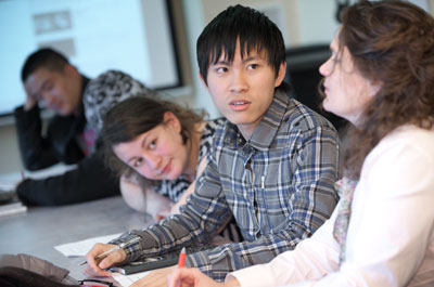 Jing Xuan Yang of China confers with Laura Qualliontine while Helena Gharios of Lebanon looks on.