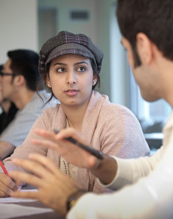 Amal Alzahrani of Saudi Arabia and Shahriar Beigi of Iran work on a lesson together. 