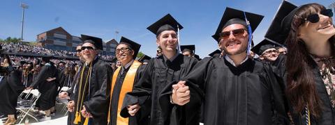 Graduates holding hands