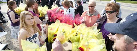 Folks lined up to purchase flower bouquets