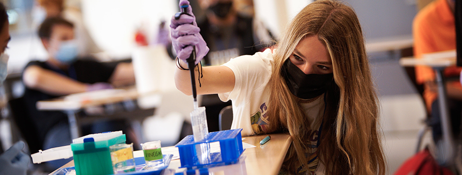 Femalte student using pipette at UNH Tech Camp