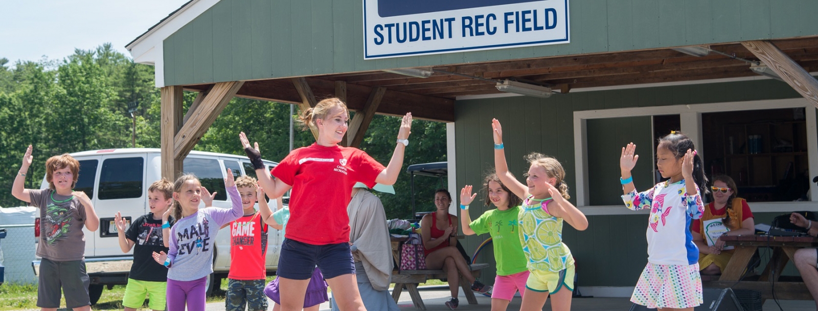 Camp Wildcat students dancing led by staff member