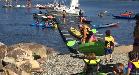 Group of students at Sailing Camp heading into the water
