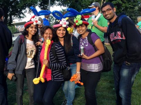 International students with balloon animals on their heads